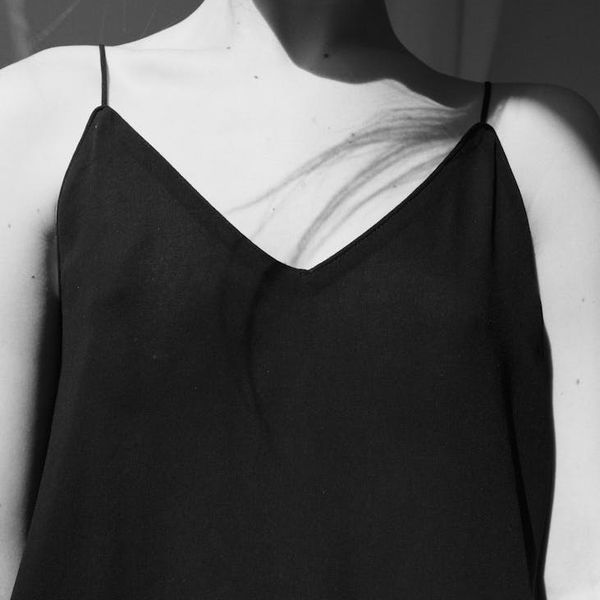 Woman with calm expression focusing, with abstract light lines representing vision.